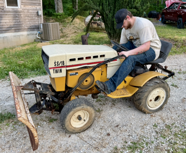 Josh plowing gravel on grandpa's vintage garden tractor
